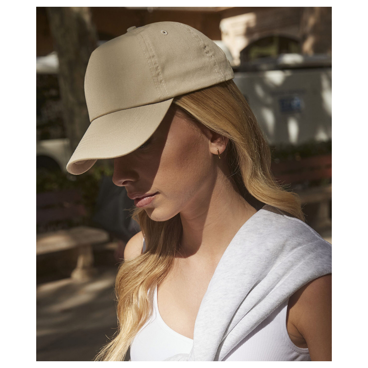 Beechfield BC010 original cap in the colour sand being worn by a woman showing a curved peak